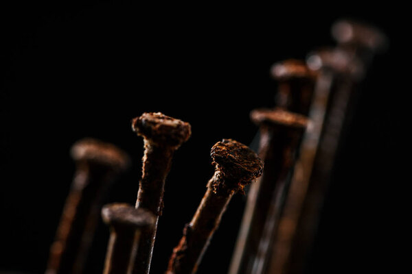 close up view of vintage rusty nails isolated on black