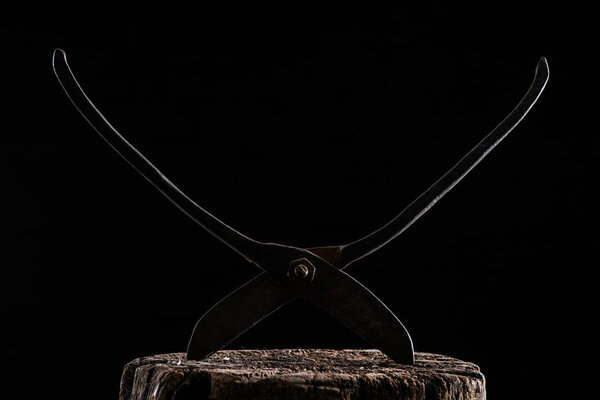  закрытый вид на ретро ржавые ножницы на деревянном стеллаже, изолированном на черном
