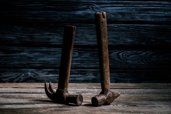 close up view of retro hammers on wooden planks surface