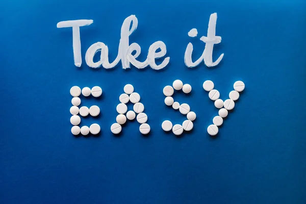 Top View Lettering Take Easy Made White Pills Blue Background — Stock Photo, Image