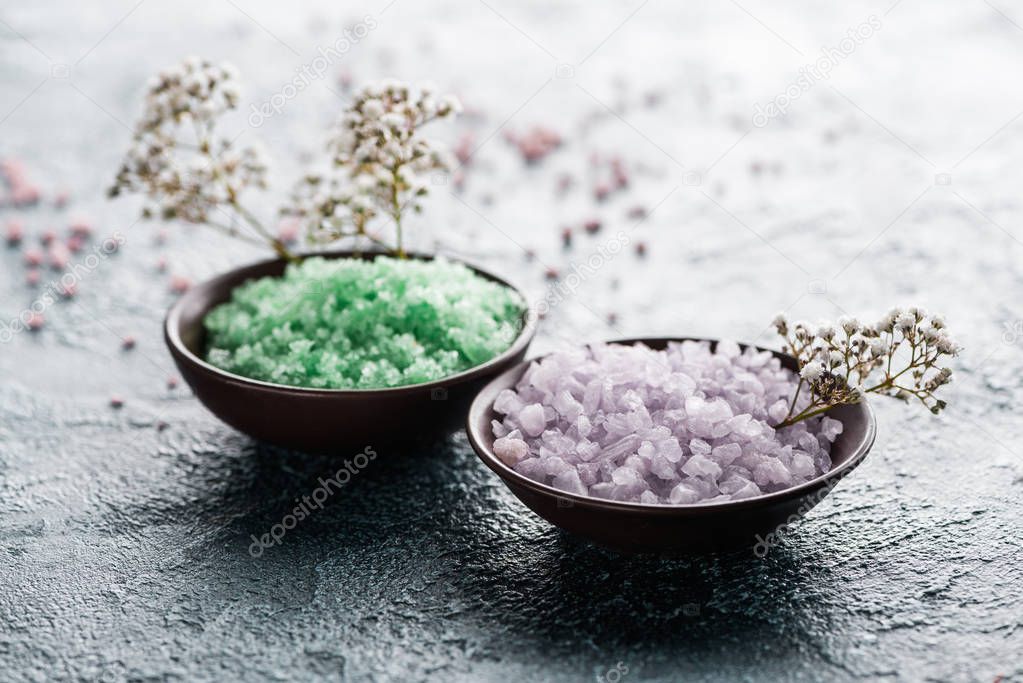 close-up view of sea salt in bowls and small white flowers