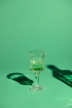 close-up shot of lead glass of absinthe on green surface clipart
