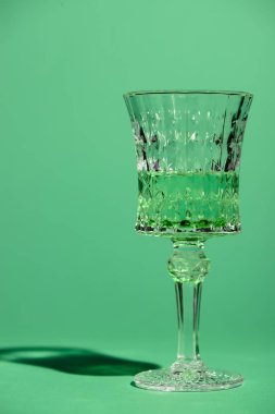 close-up shot of crystal glass of absinthe isolated on green clipart