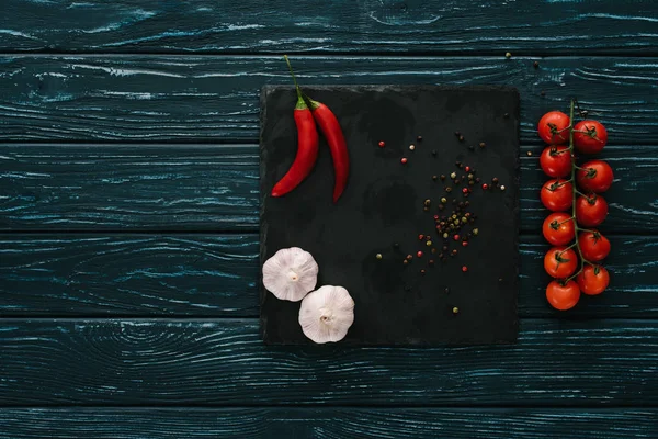 Top view of vegetables and chilli peppers on stone cutting board on green wooden tabletop — Stock Image Top View Vegetables Chilli Peppers Stone Cutting Board Green Wooden Stock Image