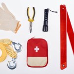 Flat lay with first aid kit and automotive accessories isolated on white