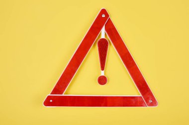 top view of warning triangle road sign isolated on yellow clipart