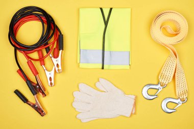flat lay with arrangement of automotive accessories isolated on yellow clipart