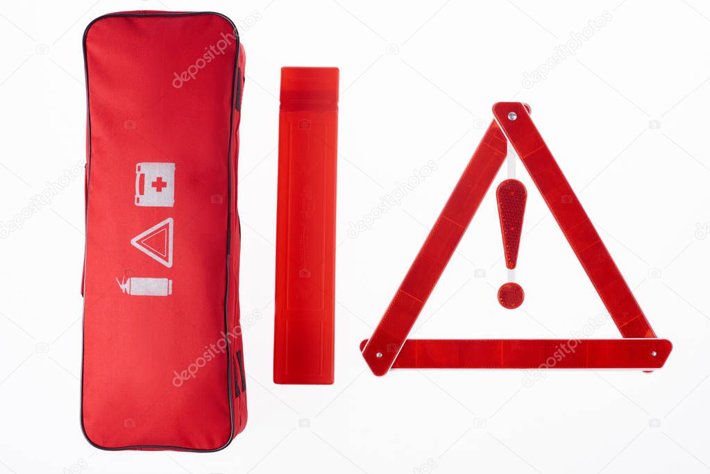 top view of red warning triangle and handbag isolated on white