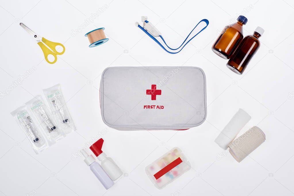 flat lay with automotive first aid kit with various medicines isolated on white