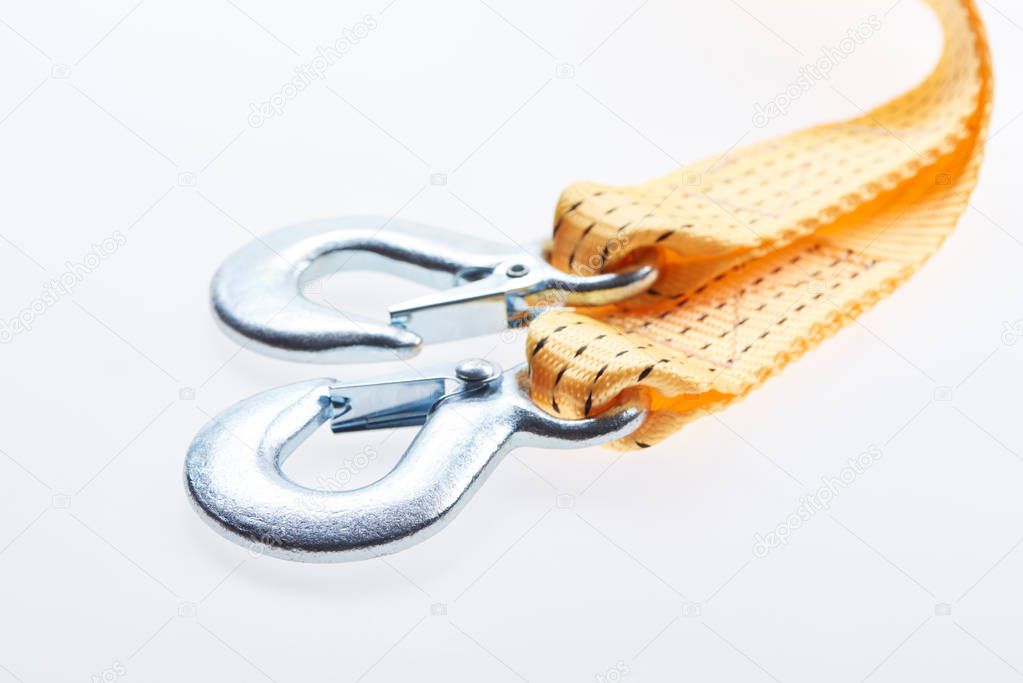 close up view of yellow car tow rope isolated on white