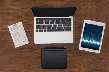 Ekranda boş ekran, hesap makinesi, ders kitabı ve grafik ile dijital tablet ile dizüstü üstten görünüm 