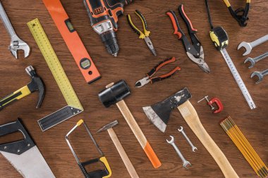 top view of arranged various tools on wooden table clipart