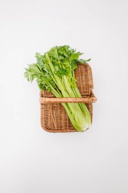 top view of green celery on basket isolated on white clipart