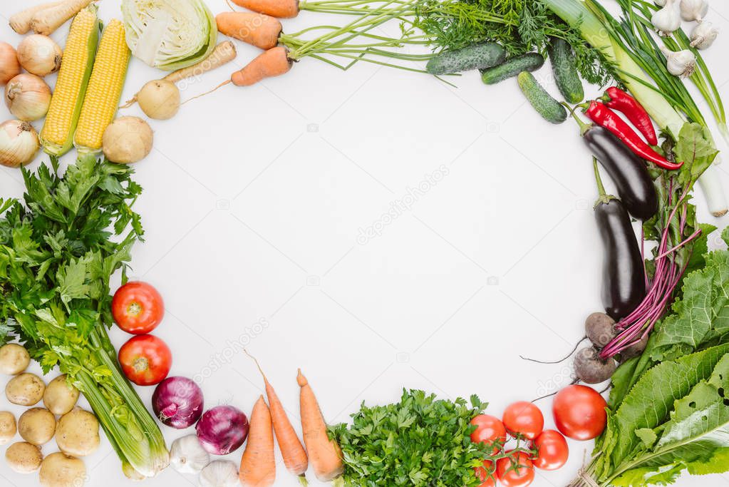 flat lay with fresh autumn vegetables arranged with blank space in middle isolated on white