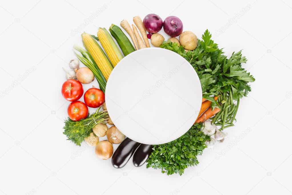 top view of food composition with fall harvest with empty plate in middle isolated on white