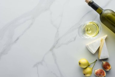 top view of glass of wine, cameembert cheese pieces, figs and pears on white marble tabletop clipart
