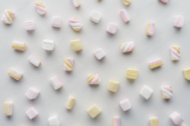 top view of colored marshmallows on white surface clipart