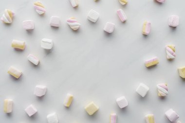 top view of tasty colored marshmallows on white surface clipart