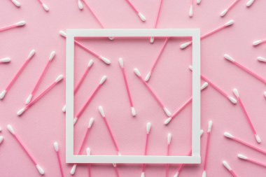 top view of cotton swabs with white frame isolated on pink, beauty concept clipart