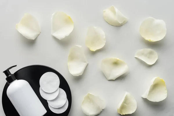 Top View Bottle Cream Cosmetic Pads Plate Scattered Rose Petals — Stock Photo, Image