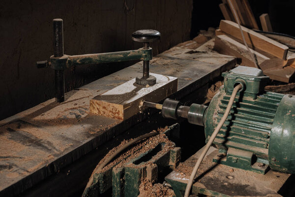 close up view of woodworkers workplace with equipment and wood at workshop