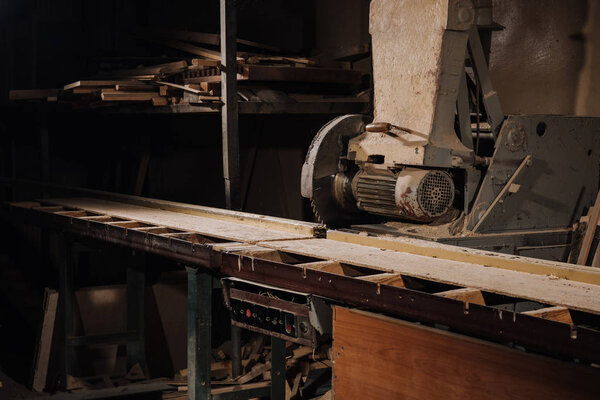 close up view of circular saw and materials at wooden workshop