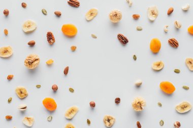 flat lay with delicious dried fruits and nuts with copy space isolated on white background clipart