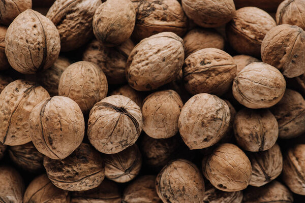 Top view of walnuts in nutshells in full screen