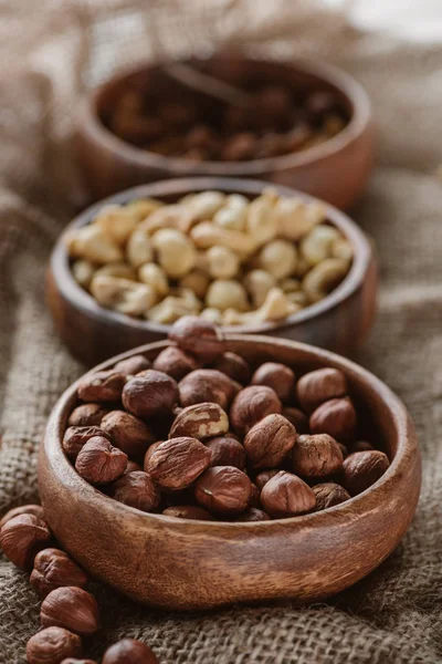 Various Nuts Wooden Bowls Sackcloth — Stock Photo, Image