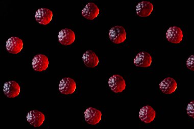 collection of red jelly candies in shape of raspberries isolated on black clipart