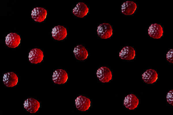 collection of red jelly candies in shape of raspberries isolated on black