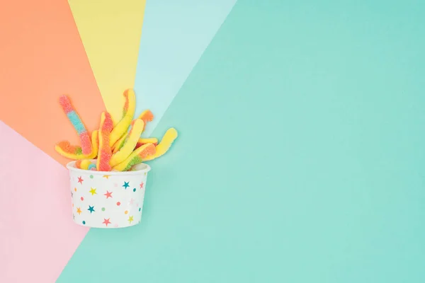 Top View Yummy Jelly Candies Paper Container Colored Surface — Stock Photo, Image