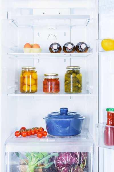 pan, preserved and ripe vegetables in fridge