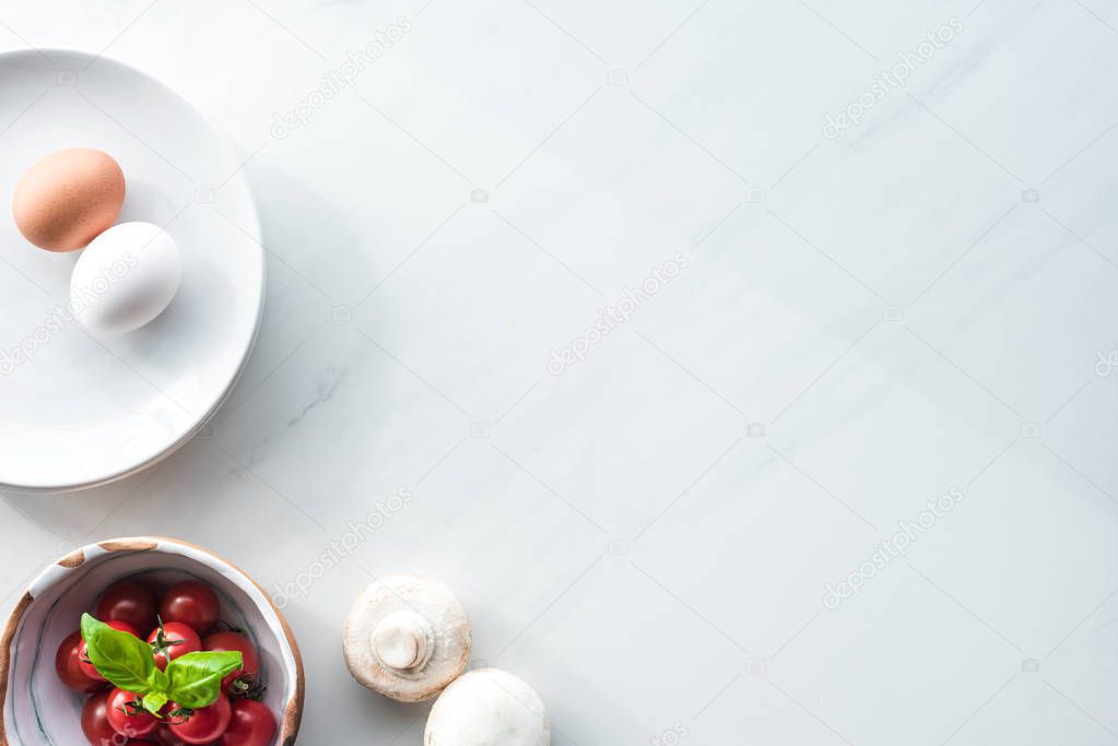 top view of ingredients for cooking omelette for breakfast on white marble surface