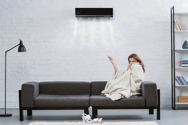 Young Woman Covered Blanket Couch Air Conditioner Hanging Wall Blowing — Stock Photo, Image