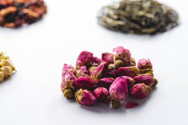 collection of dried herbal natural tea on white surface