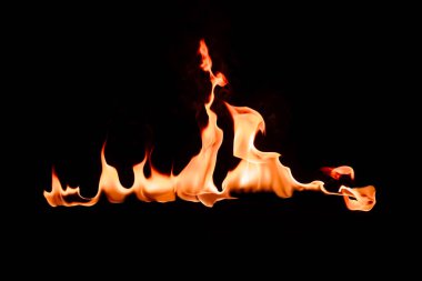 close up view of burning orange flame on black background clipart