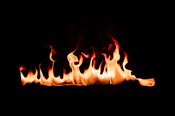 close up view of burning flame on black backdrop