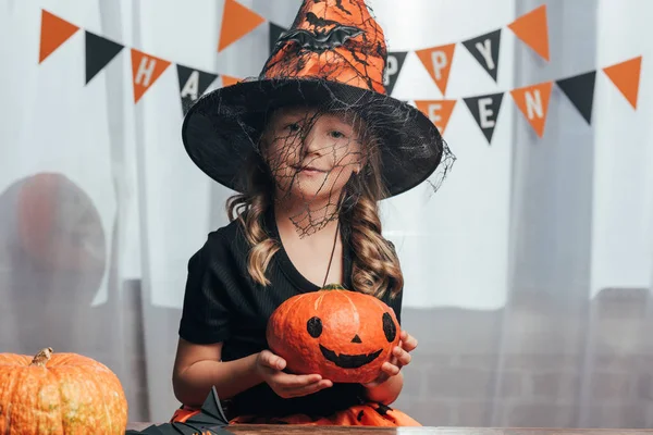 Portrait Adorable Child Witch Halloween Costume Holding Pumpkin Home — Stock Photo, Image