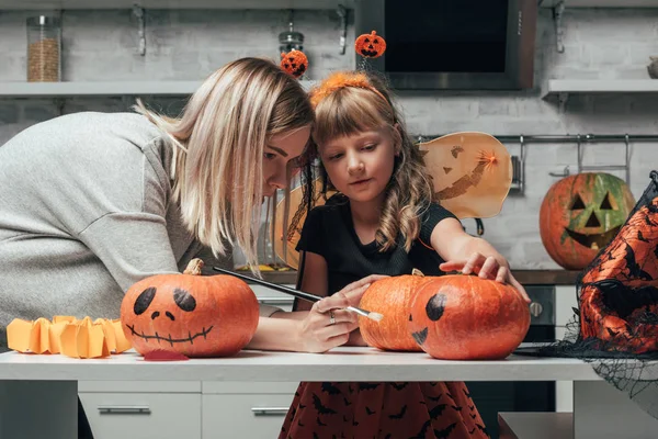 Young Woman Little Sister Painting Pumpkins Halloween Together Kitchen Home — Stock Photo, Image