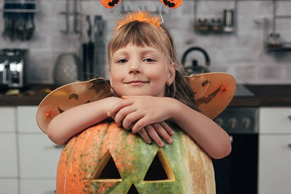 Portrait Smiling Kid Halloween Costume Leaning Big Carved Pumpkin Home — Stock Photo, Image