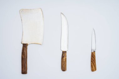 top view of cleaver and kitchen knives with wooden handles isolated on grey  clipart