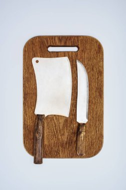 top view of kitchen knife and cleaver on wooden cutting board isolated on grey   clipart