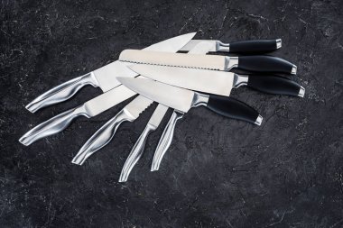 set of various kitchen knives arranged on black, top view   clipart