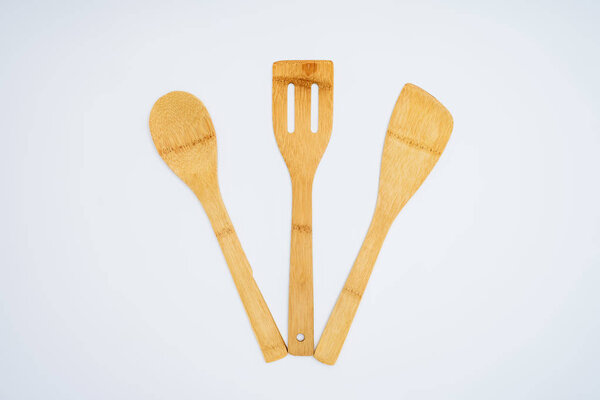 top view of set of wooden kitchen utensils isolated on grey
