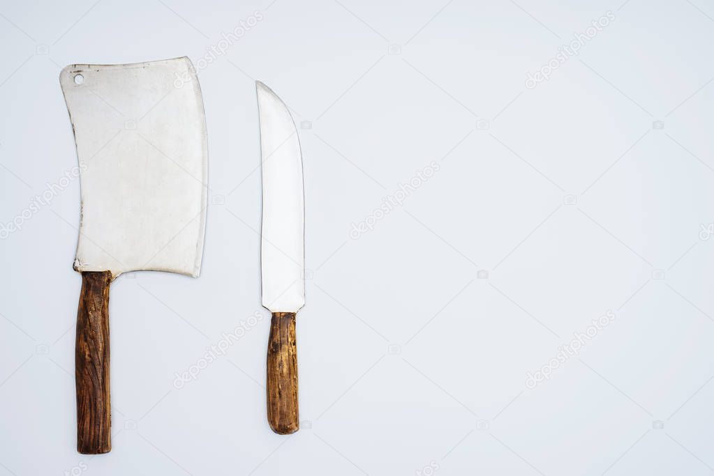 set various kitchen knives with wooden handles isolated on grey, top view