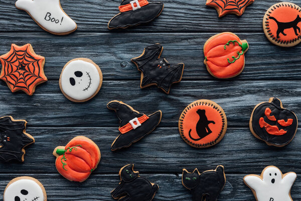 top view of arranged delicious halloween cookies on wooden table 