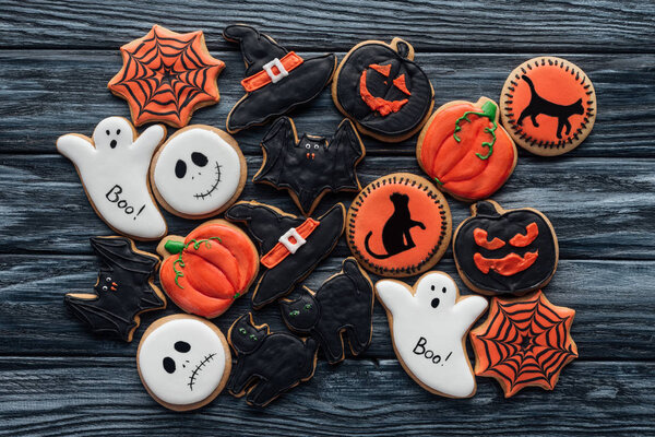 top view of pile of homemade halloween cookies on wooden table 