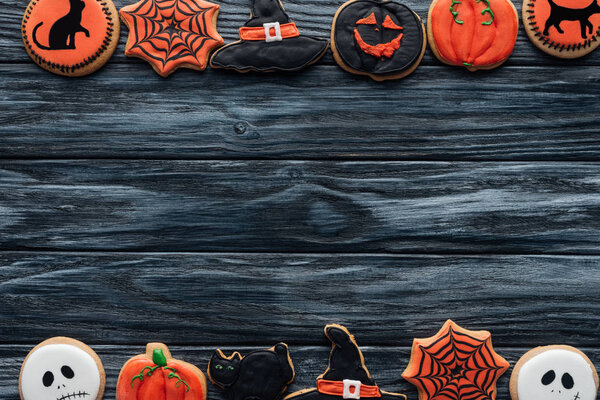 top view of arranged halloween homemade cookies placed in rows on wooden background 
