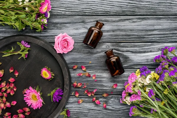Top View Bottles Natural Herbal Essential Oils Pink Violet Flowers — Stock Photo, Image